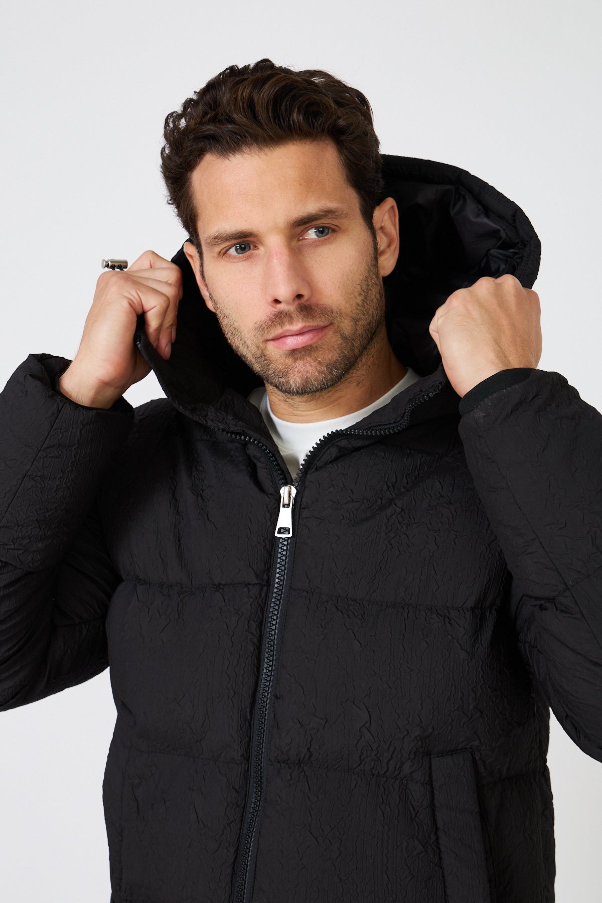 Men's light-colored quilted down jacket with hood