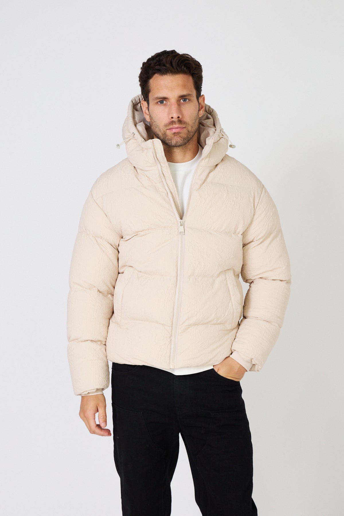 Men's light-colored quilted down jacket with hood