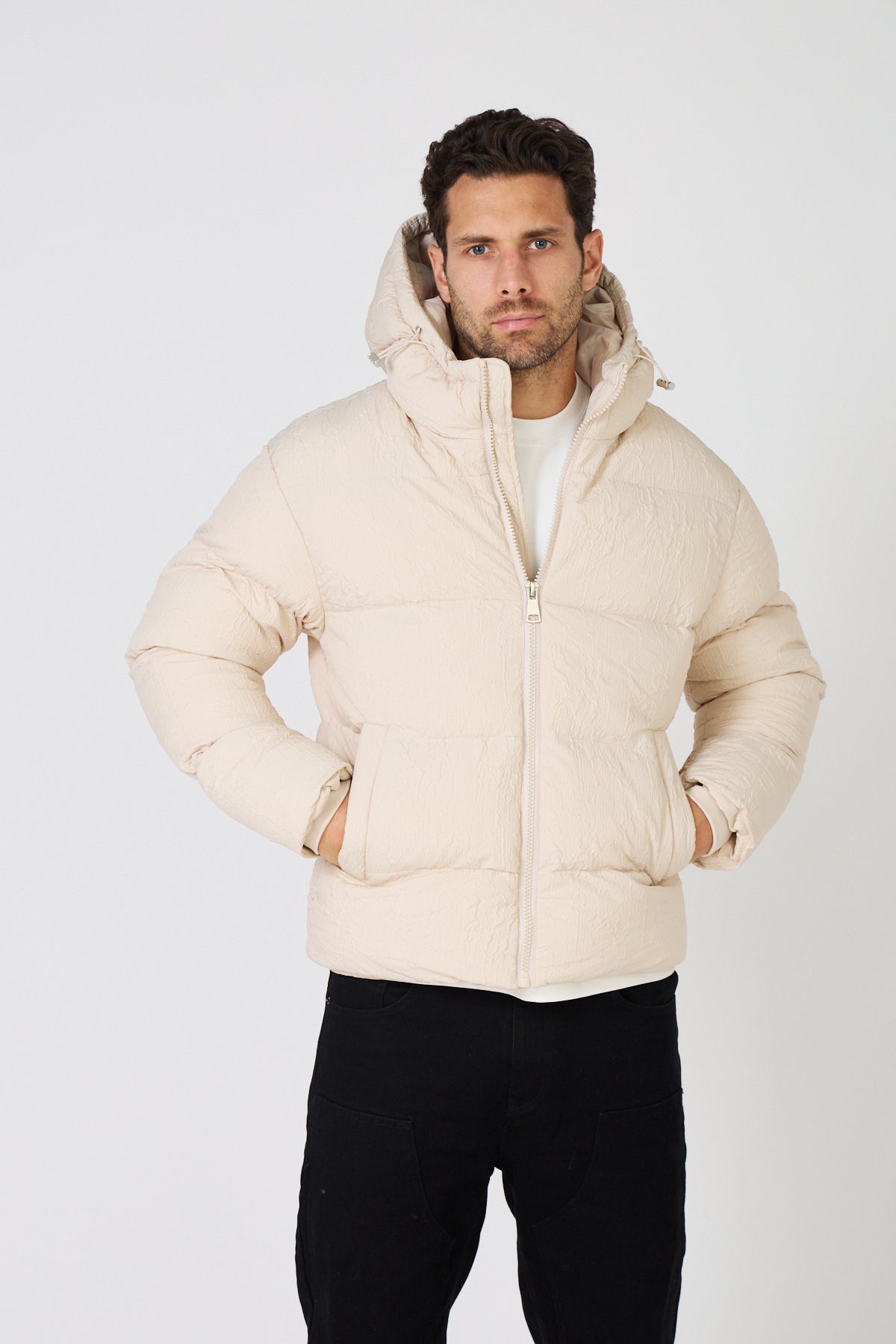 Men's light-colored quilted down jacket with hood