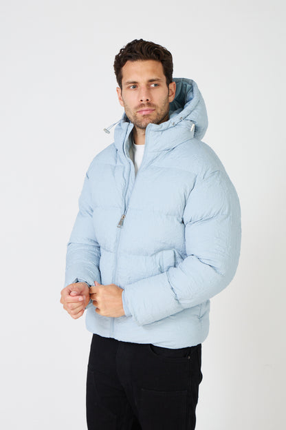 Men's light-colored quilted down jacket with hood